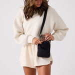 Small shoulder bag for women featuring interior zip pockets and snap slips #black