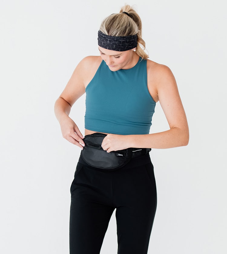 model size 4 wearing black petite belt bag around waist