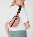 model size 4 wearing dusty mauve regular belt bag crossbody (around back)