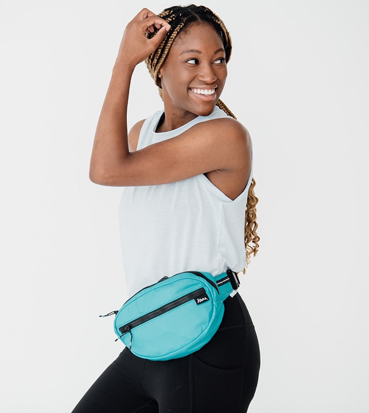 model size 4 wearing teal petite belt bag around waist