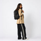 Black foldable carry-on daypack angled front view. #black