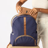 women adding a laptop disha sleeve to the backpack #indigo_and_camel