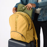  Laptop sliding into back sleeve of amber travel backpack. #amber_yellow