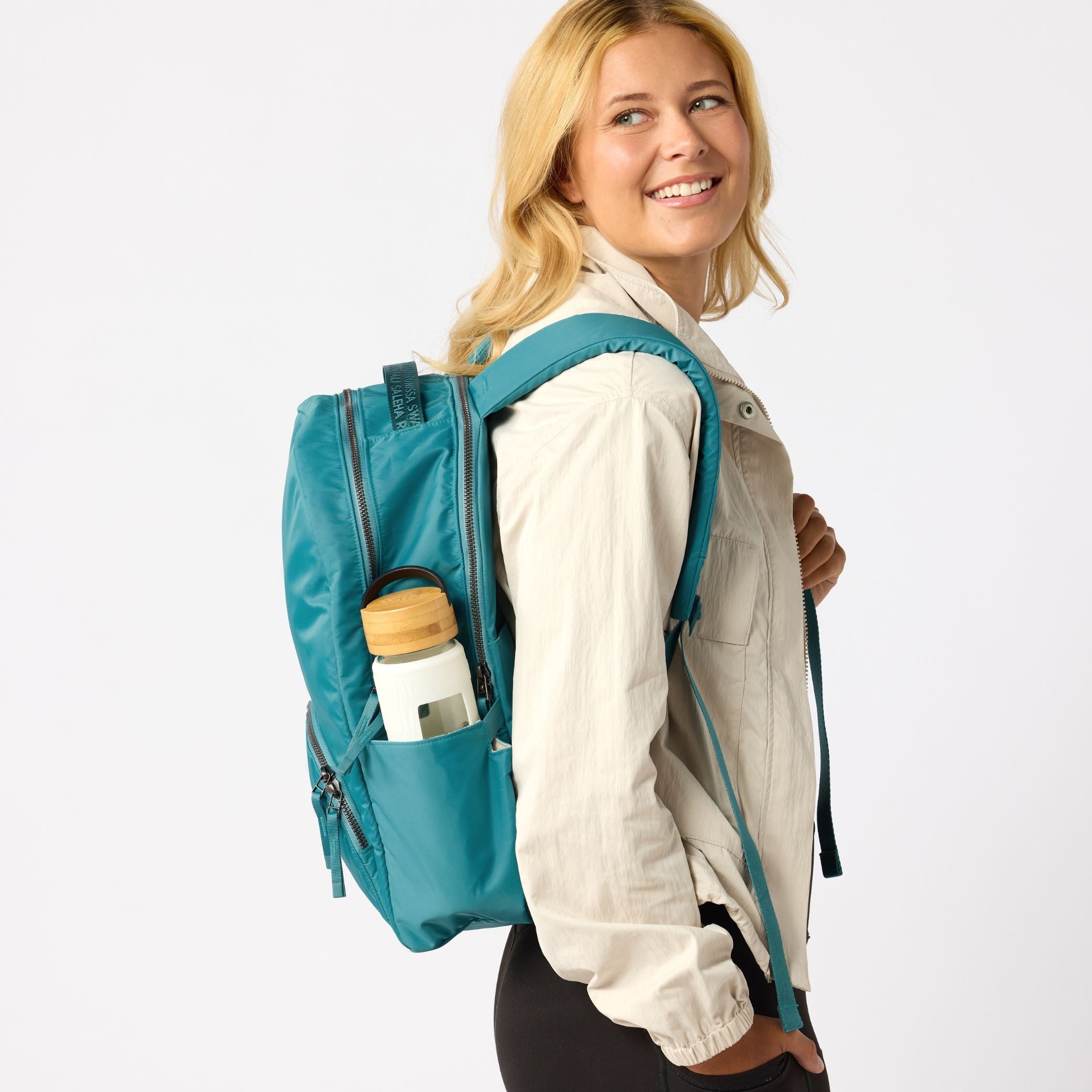 Teal travel backpack back view with shoulder straps. #solid_teal