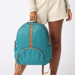  Woman wearing teal carry-on travel backpack front view. #teal_and_camel