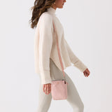 Pink crossbody bag with a strap on a white background #blush