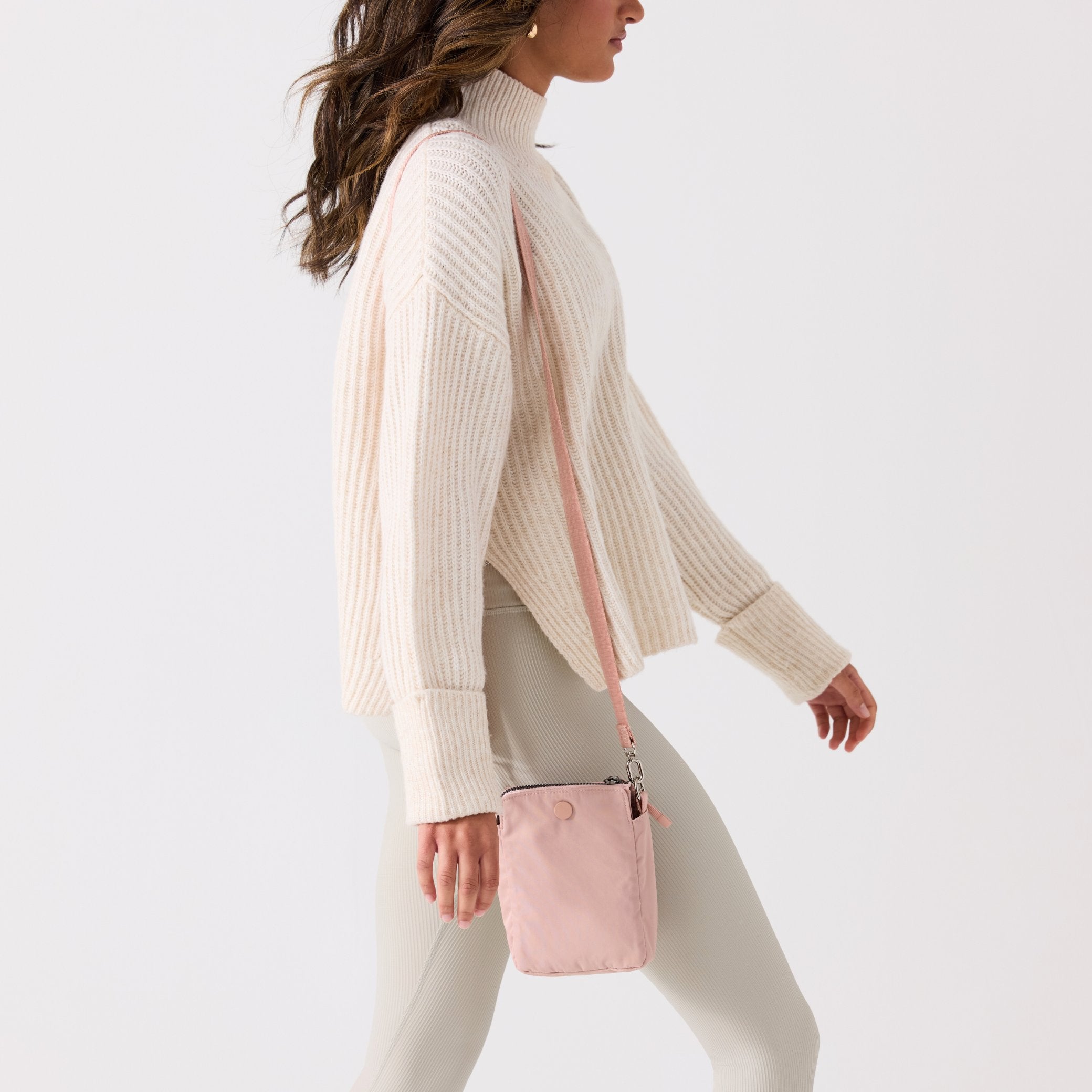 Pink crossbody bag with a strap on a white background #blush