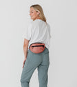 model size 4 wearing dusty mauve petite belt bag around waist