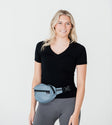 model size 4 wearing stone blue petite belt bag around waist
