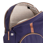 Indigo and Camel Geeta nylon backpack with camel trim open at the top, revealing the gray and white printed-name lining inside. #indigo_and_camel