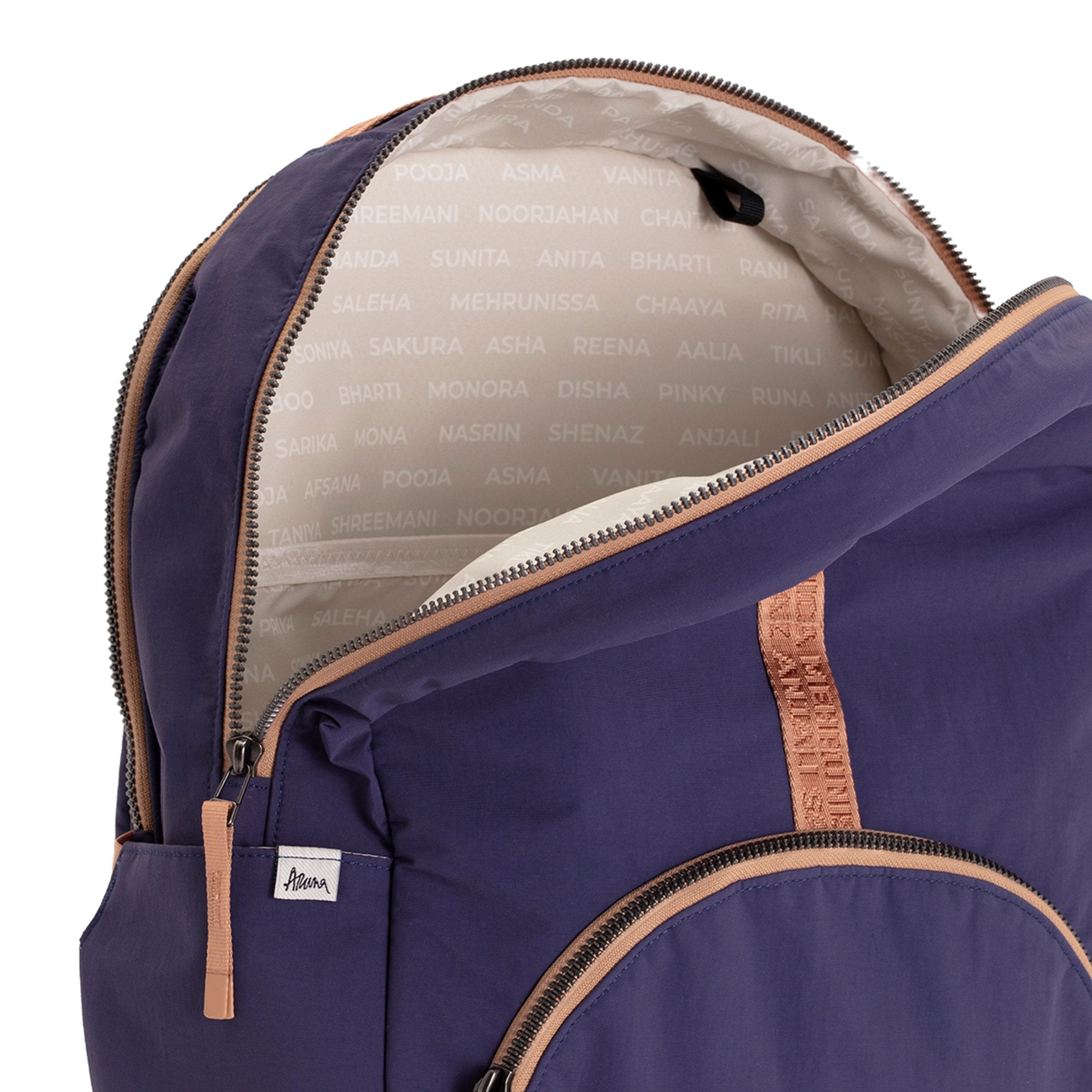 Indigo and Camel Geeta nylon backpack with camel trim open at the top, revealing the gray and white printed-name lining inside. #indigo_and_camel