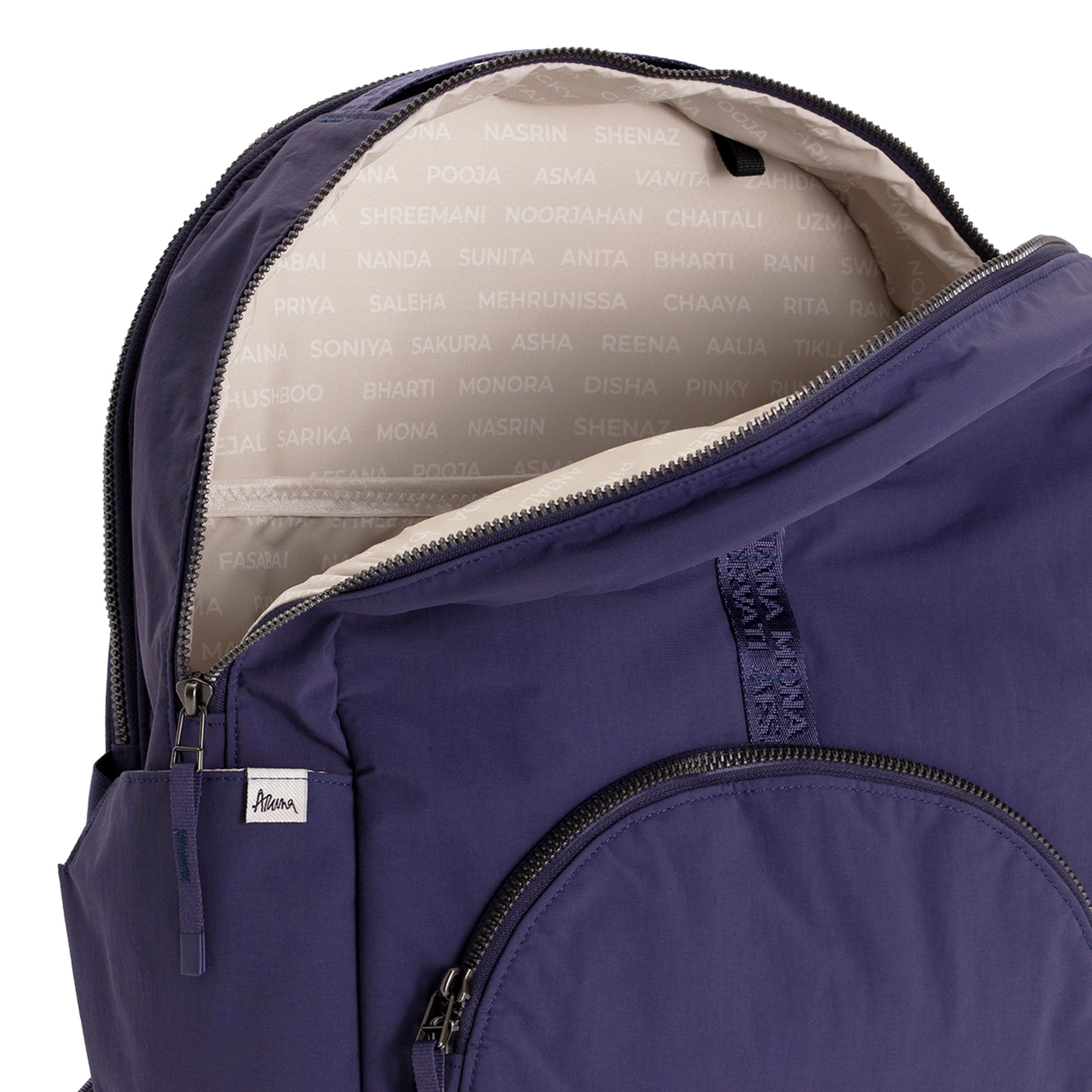 Indigo Geeta nylon backpack open at the top, revealing the gray and white printed-name lining inside the main compartment. #indigo