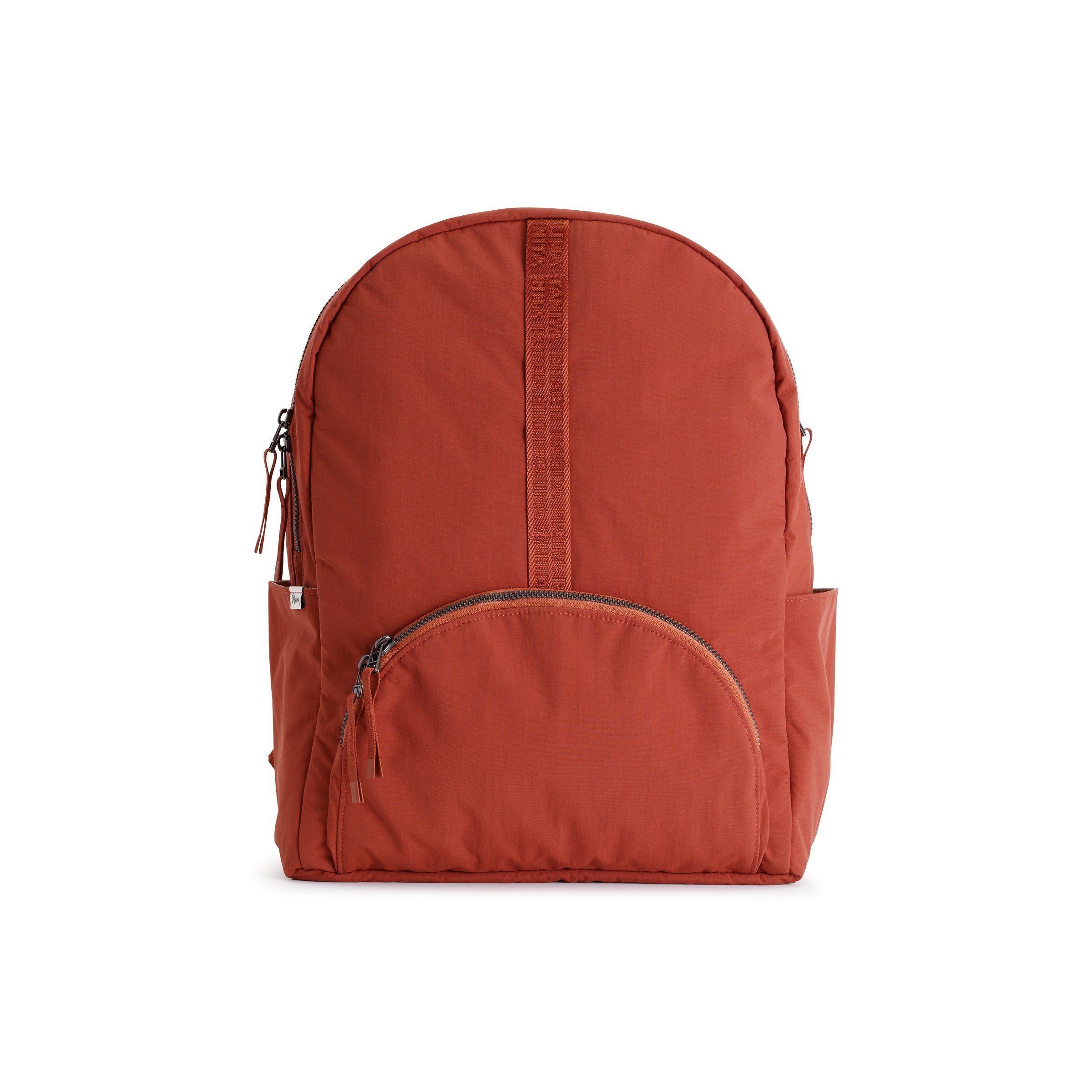 Rust Red Geeta nylon backpack, front view showing the rounded zip front pocket and top grab handle. #rust_red