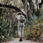 Person with a backpack walking through a lush forest - #olive sonu backpack