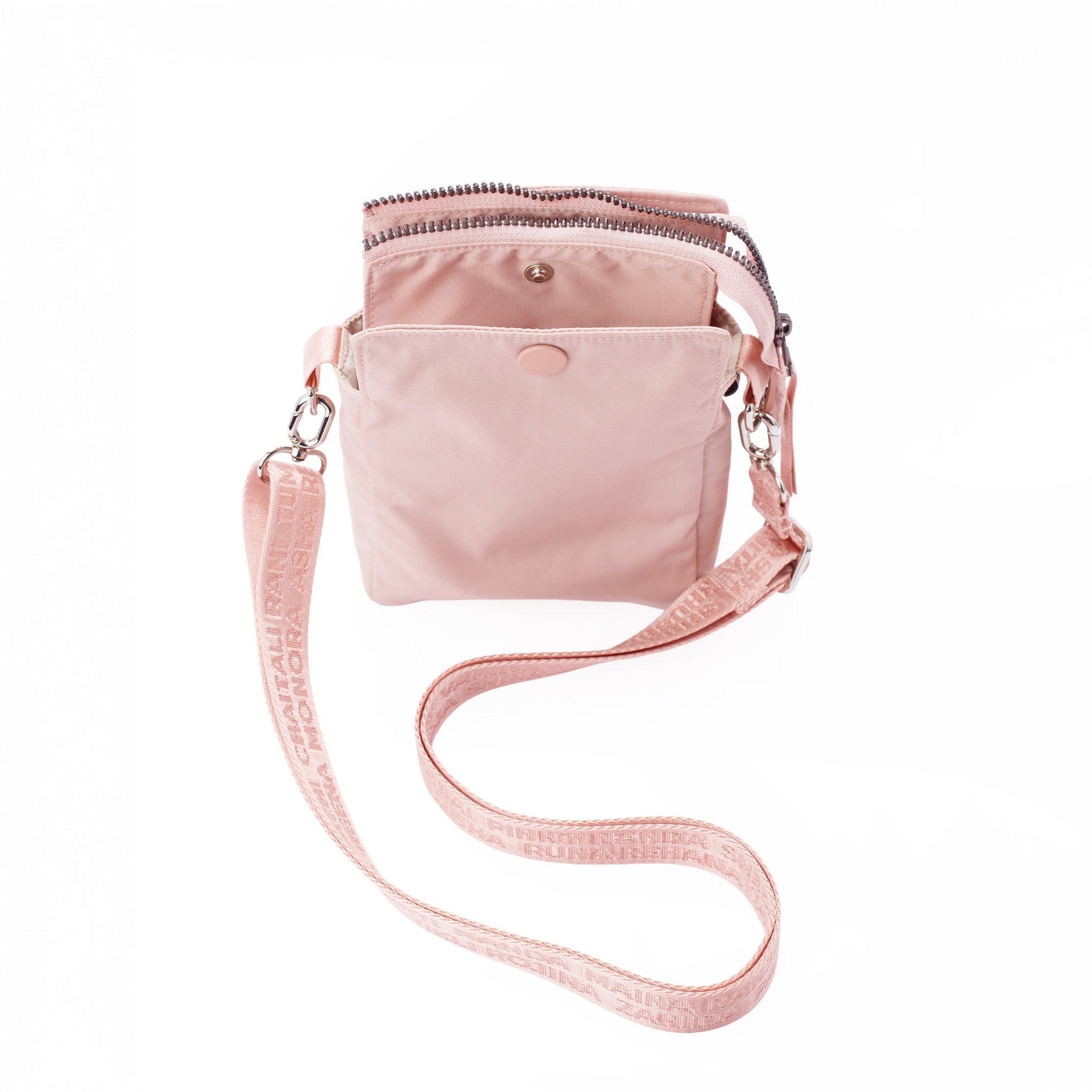 Pink crossbody bag with a strap on a white background #blush