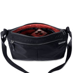 Shree Crossbody in black — interior view with two zip pockets #black